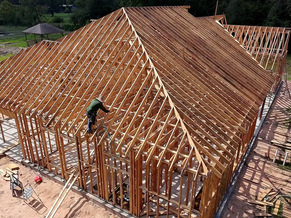 Aerial view of wood framing rising on a completed concrete slab foundation