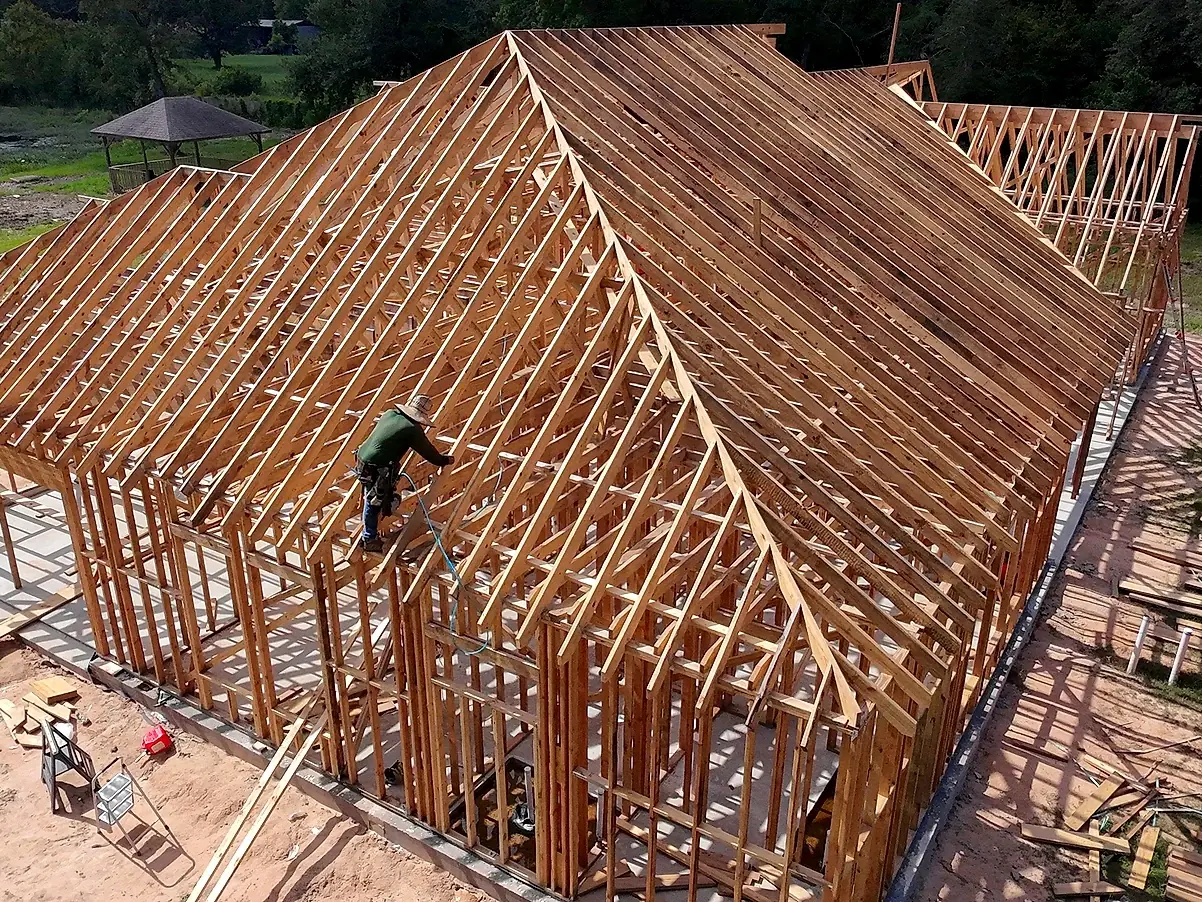 Aerial view of wood framing rising on a completed concrete slab foundation