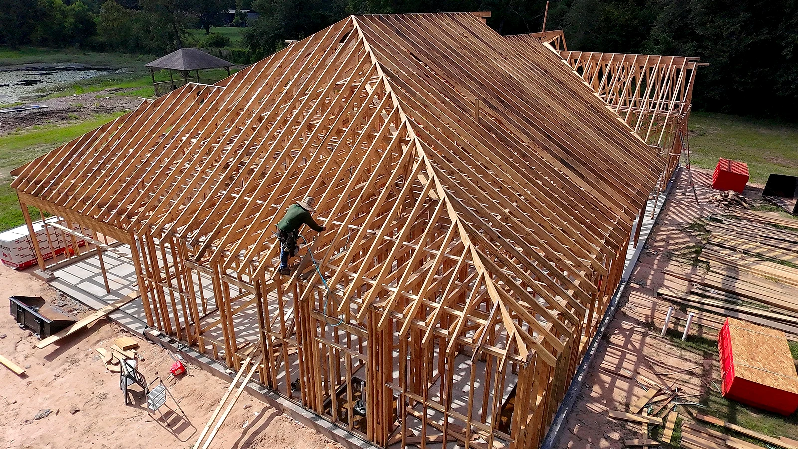 Aerial view of wood framing rising on a completed concrete slab foundation